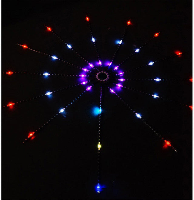 LED firework strip light mounted on a dark wall, lit in red, blue and purple