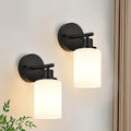 Three light bathroom vanity light with clear glass shades mounted above a mirror