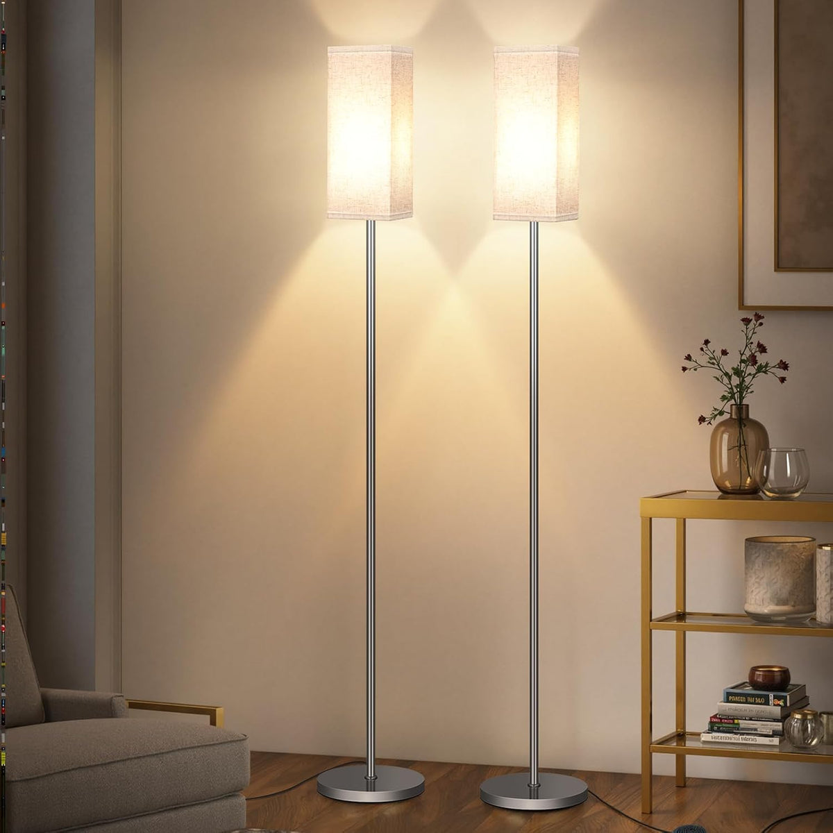 Minimalist standing floor lamp with fabric drum shade beside a sofa in a living room