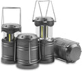 Collapsible LED camping lantern glowing on a table beside a tent at night