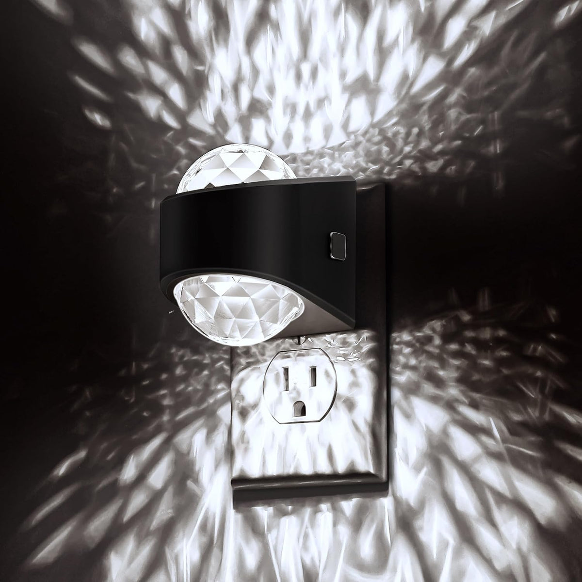 Plug in projector night light casting a soft white glow across a dark bedroom wall