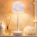 Ocean wave projector lamp casting rippling blue light across a bathroom wall