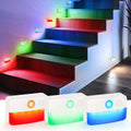 Battery powered motion sensor stair lights mounted on steps casting soft warm light