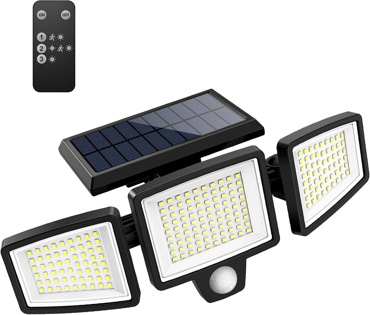 Solar outdoor security light with three motion sensor heads mounted above a garage door