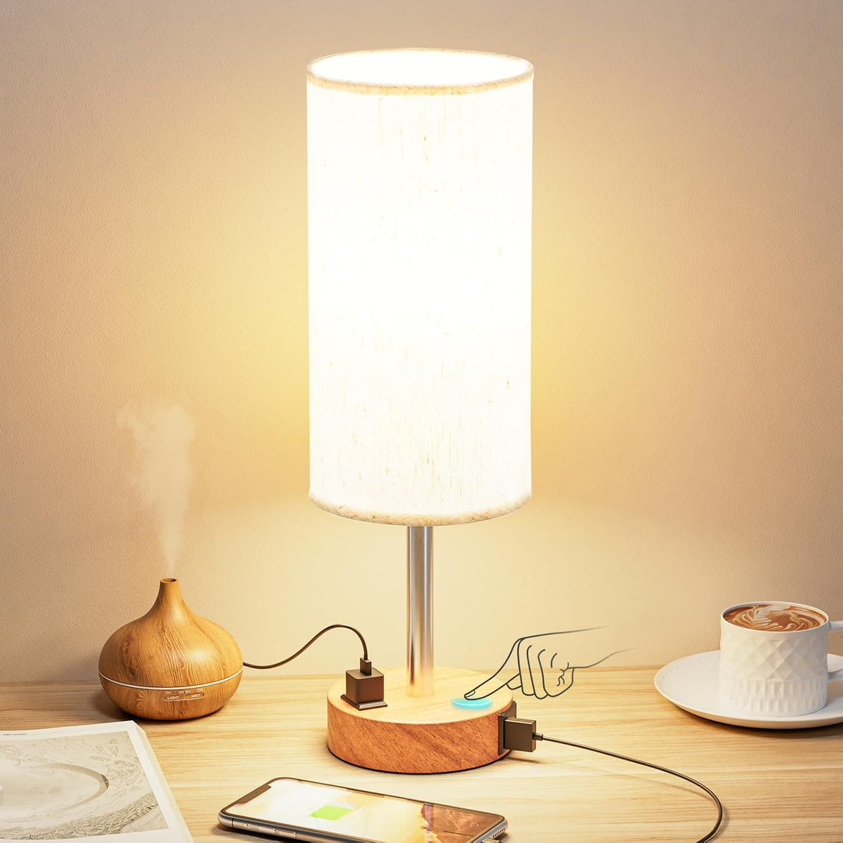 Bedside table lamp with fabric shade and USB charging ports on a wooden nightstand