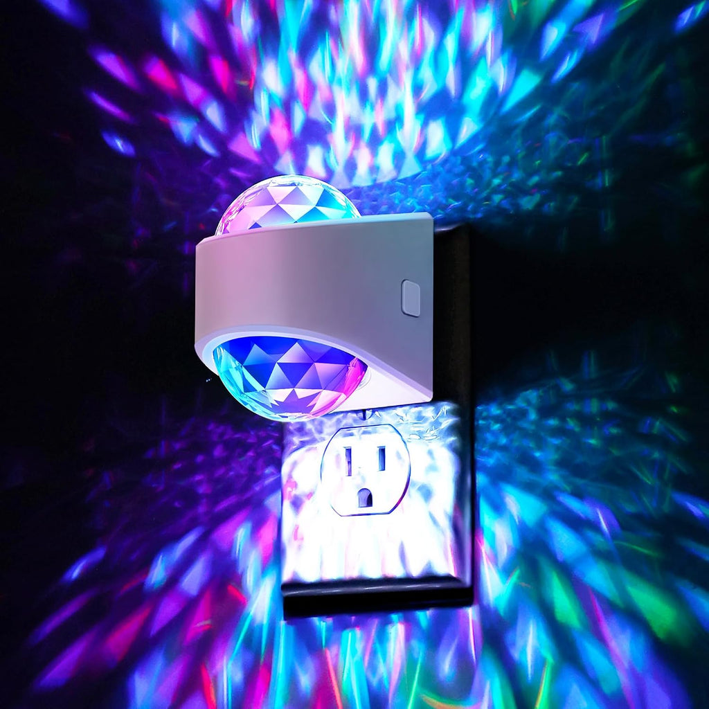 Plug in projector night light casting a soft white glow across a dark bedroom wall