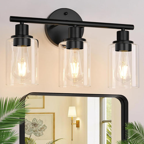 Three light bathroom vanity light with clear glass shades mounted above a mirror