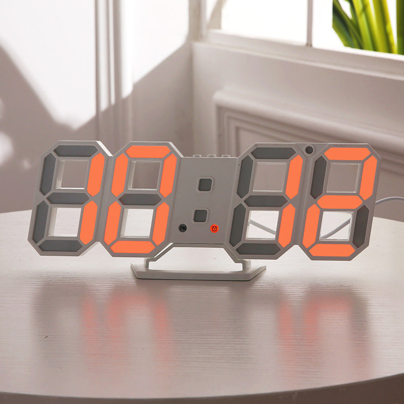 3D LED wall clock showing the time in orange digits on a table