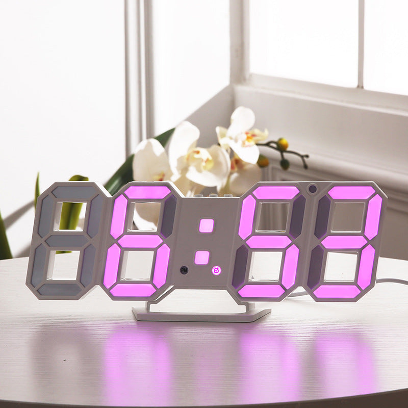 3D LED wall clock displaying pink digits on a windowsill beside flowers