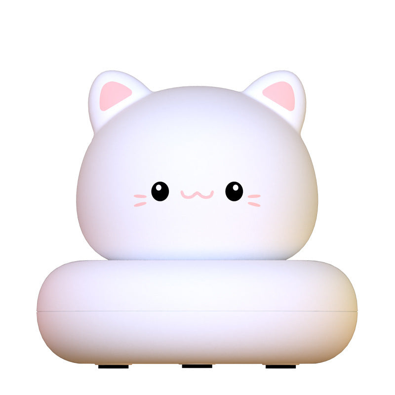 White kitten silicone night light glowing softly on a plain background