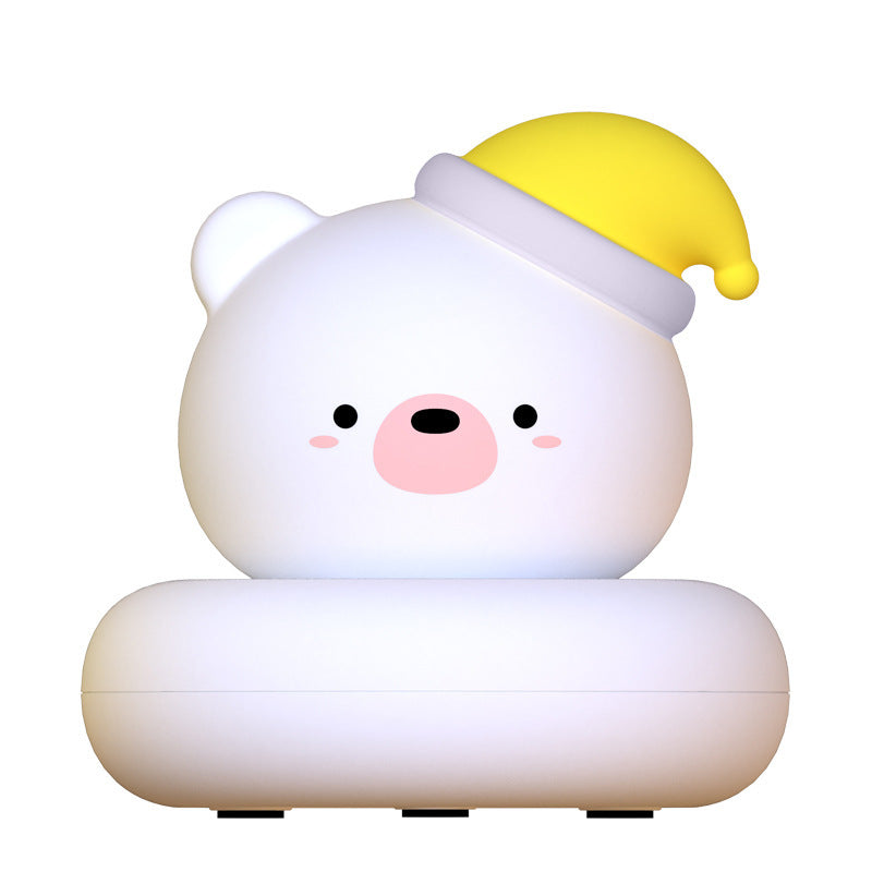 White bear silicone night light wearing a yellow nightcap