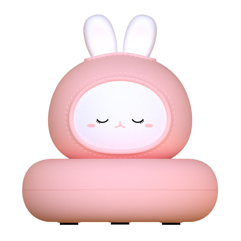 Pink bunny silicone night light with closed eyes, front view