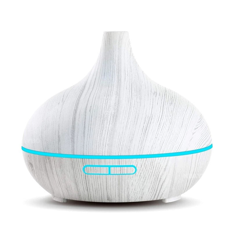 White wood-grain aroma diffuser with a teal light ring, plain background