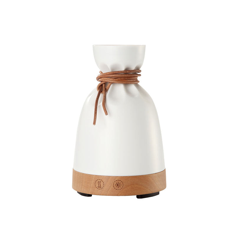 White sack-shaped wooden diffuser, unlit, plain background