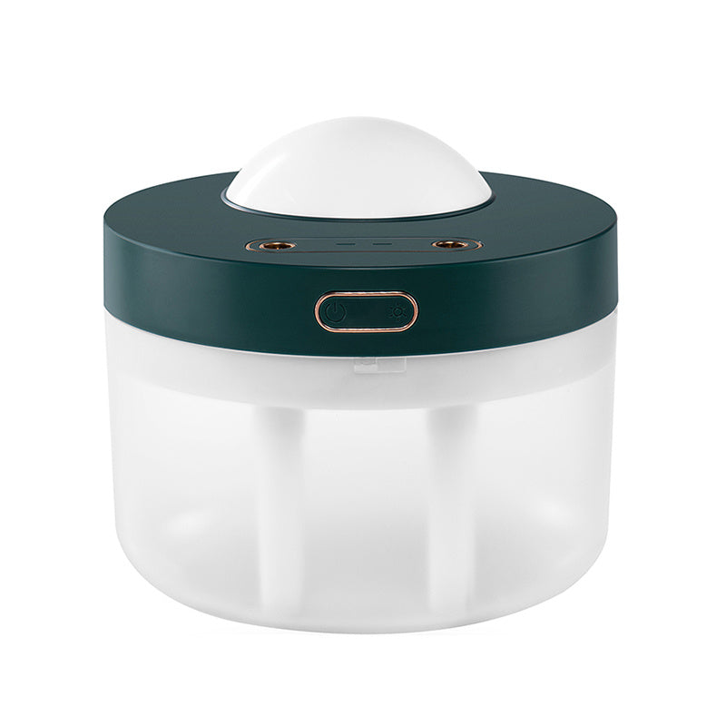 Green and white rotating aroma humidifier on a plain background