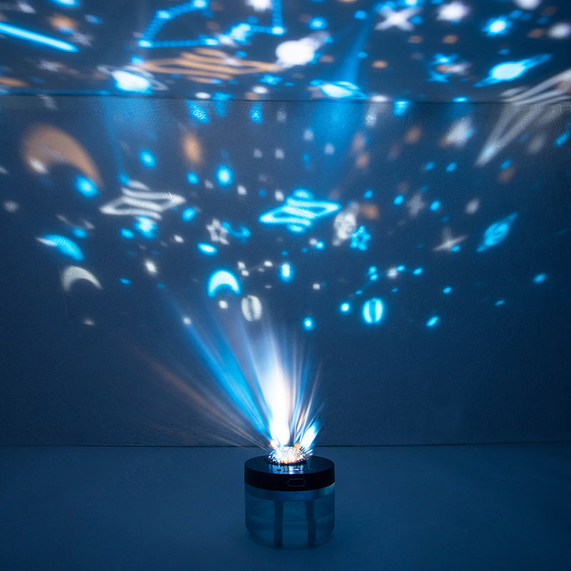 Rotating humidifier projecting blue star patterns across a dark ceiling