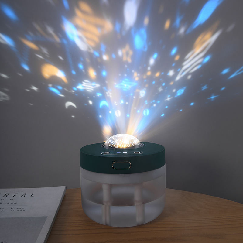 Rotating humidifier projecting coloured light patterns onto a wall beside a desk