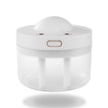 White rotating aroma humidifier with a clear tank, plain background
