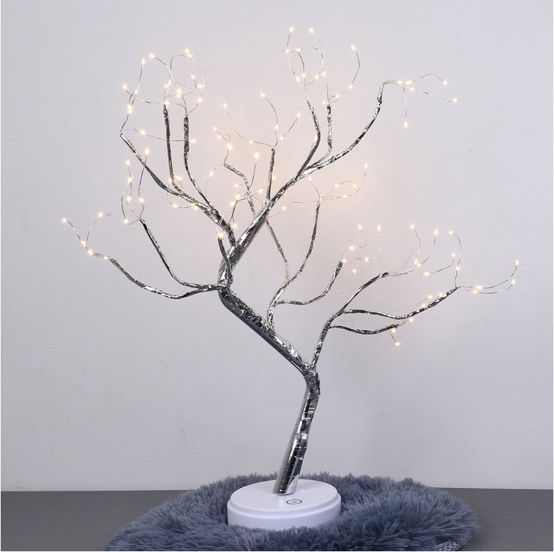 LED bonsai branch tree light lit warm white, standing on a grey rug