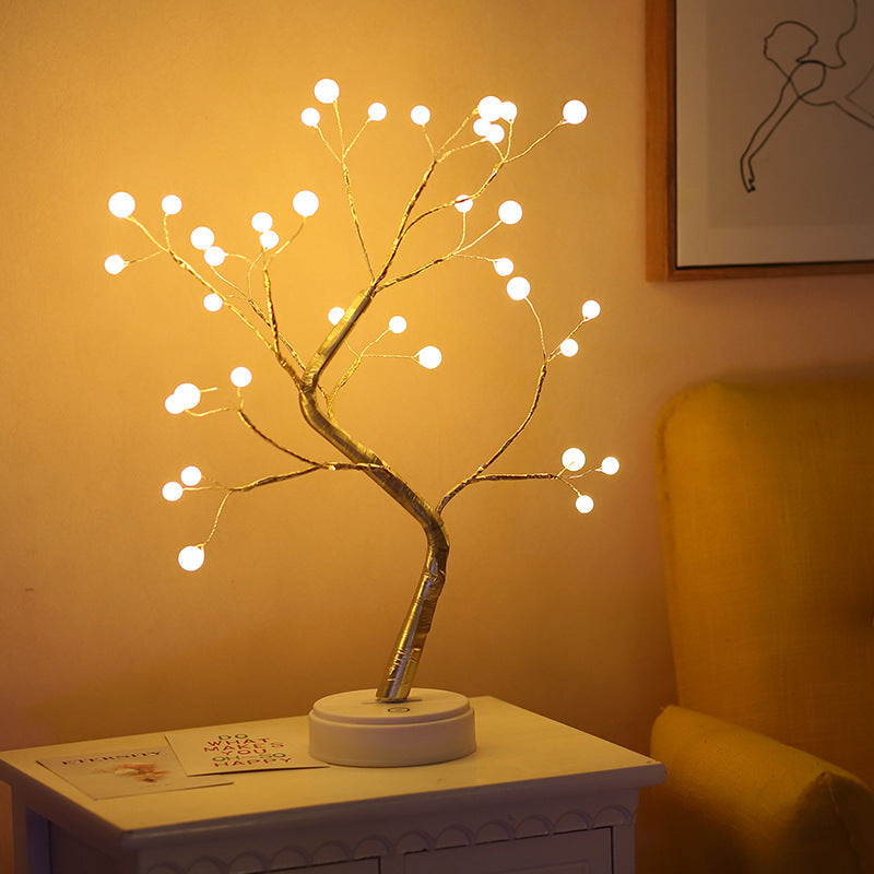 LED bonsai branch tree light with round bulb tips against a yellow wall