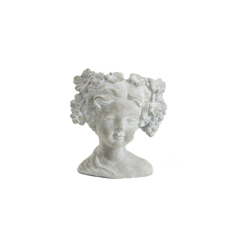 Cement bust planter of a girl with a curled bun, front view