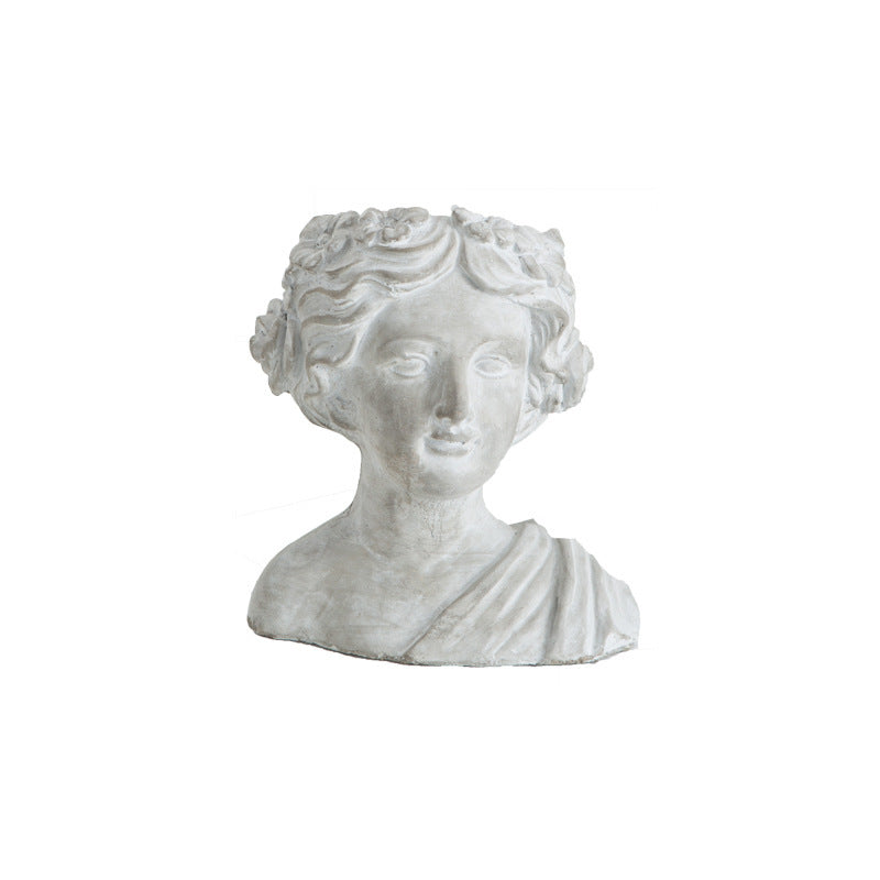 Cement bust planter of a woman with a draped shoulder, front view