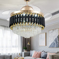 Crystal ceiling fan chandelier lit above a bright living room, blades extended