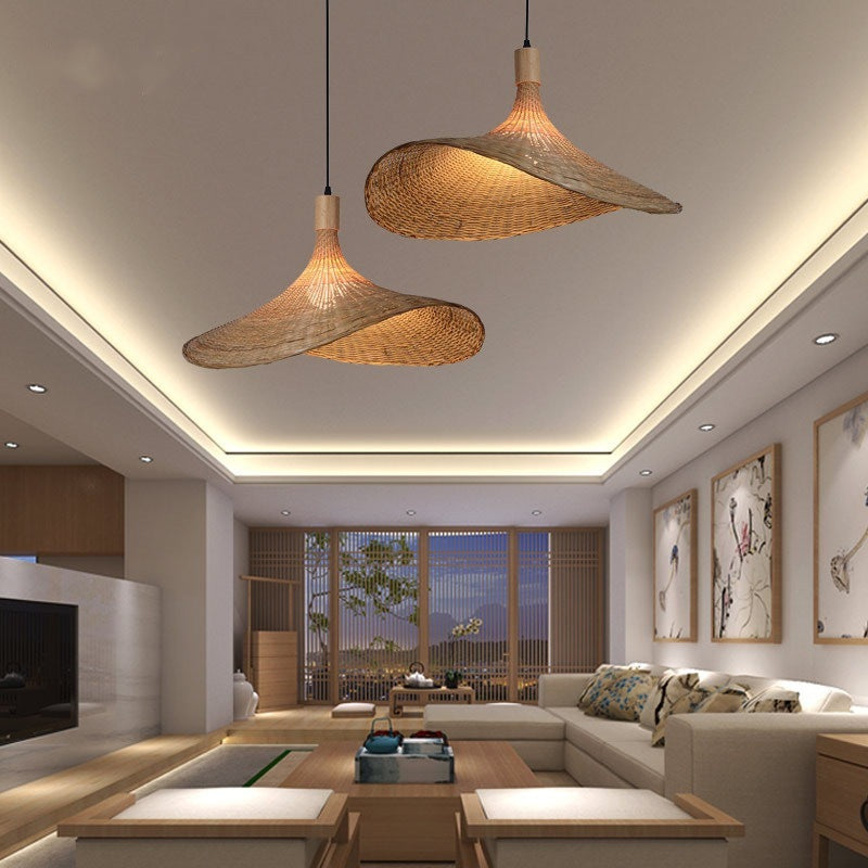 Two woven bamboo pendant shades hanging in a bright living room