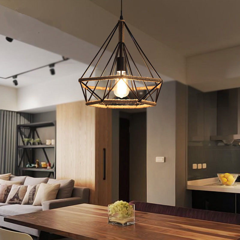 Geometric cage pendant light hanging above a dining table in an open-plan room