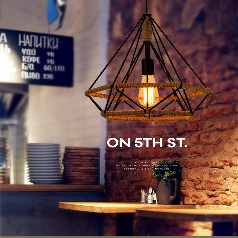 Geometric cage pendant lit above a counter in a cafe