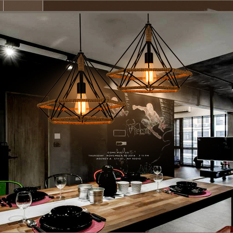 Two geometric cage pendants hanging above a long kitchen counter