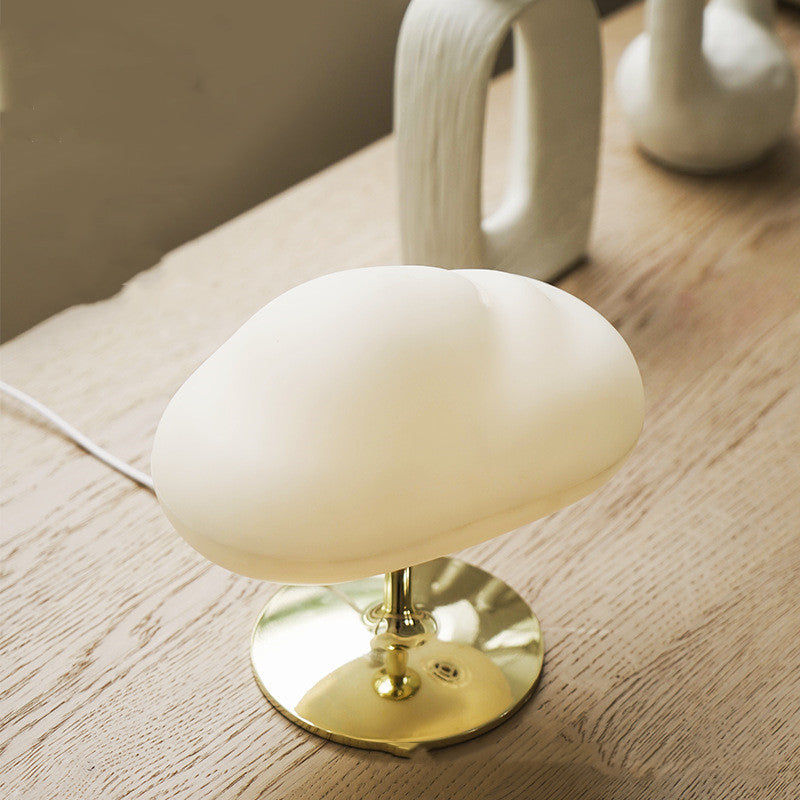 Cloud aroma diffuser on a wooden table, unlit, showing the gold stand