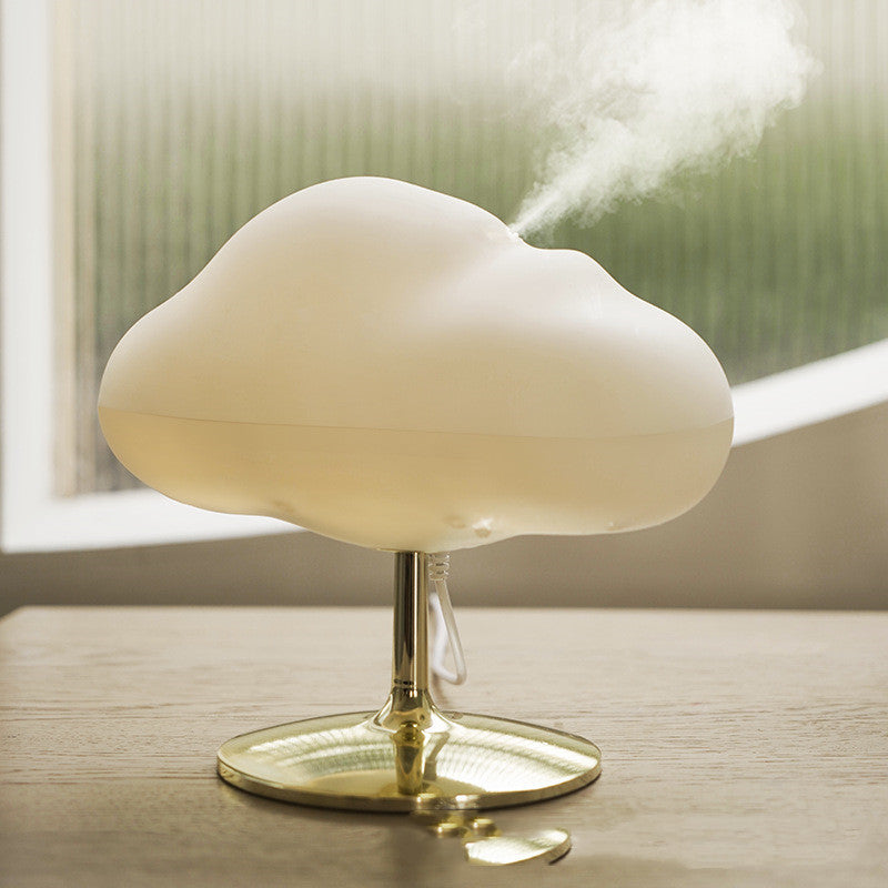 Cloud aroma diffuser releasing mist beside a bright window