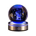 Crystal ball night light engraved with a boy under stars, lit blue on a gold base