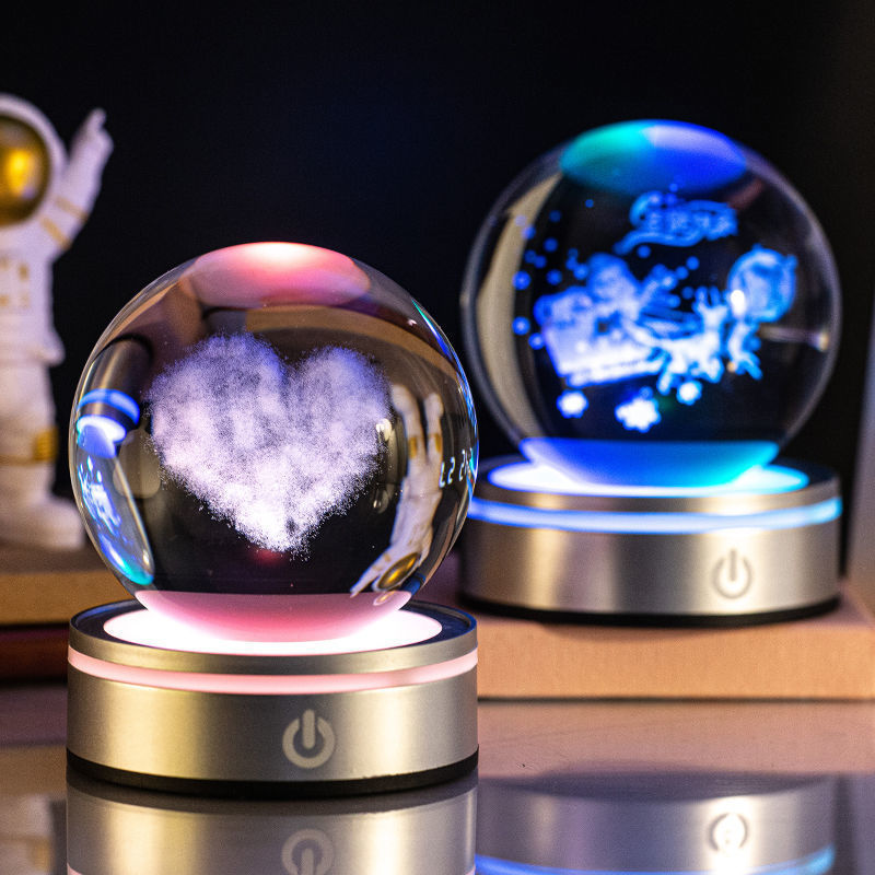 Two crystal ball night lights engraved with a heart cloud and a constellation
