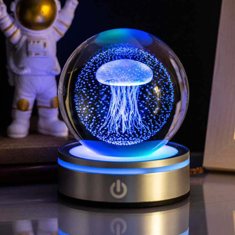 Jellyfish crystal ball night light lit blue on a silver base