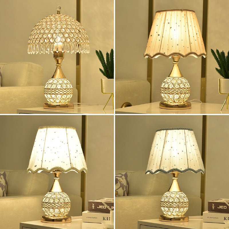 Four crystal table lamps with beaded and fabric shades shown side by side