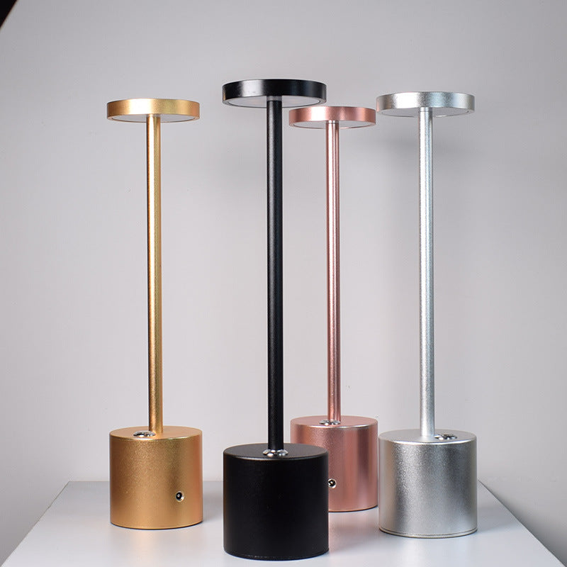 Four cordless aluminium table lamps in gold, black, rose gold and silver