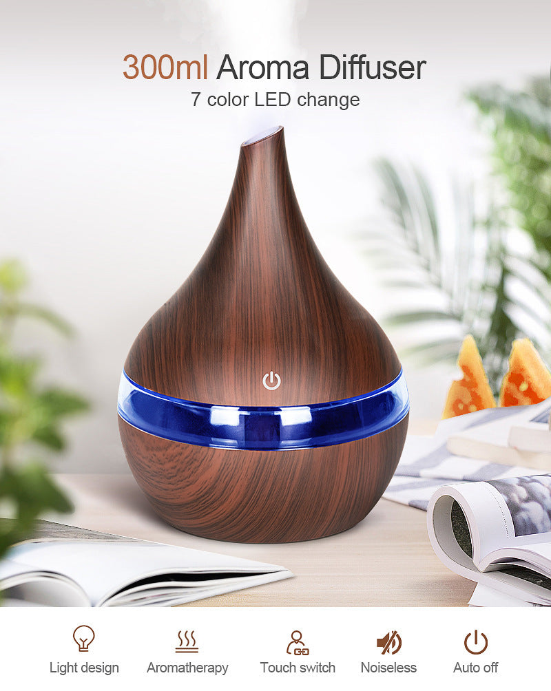 Dark wood-grain diffuser lit blue, listing its 300 ml tank and seven LED colours