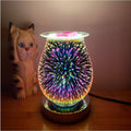 Glass firework aroma lamp lit in multicolour on a wooden base beside a cat figurine