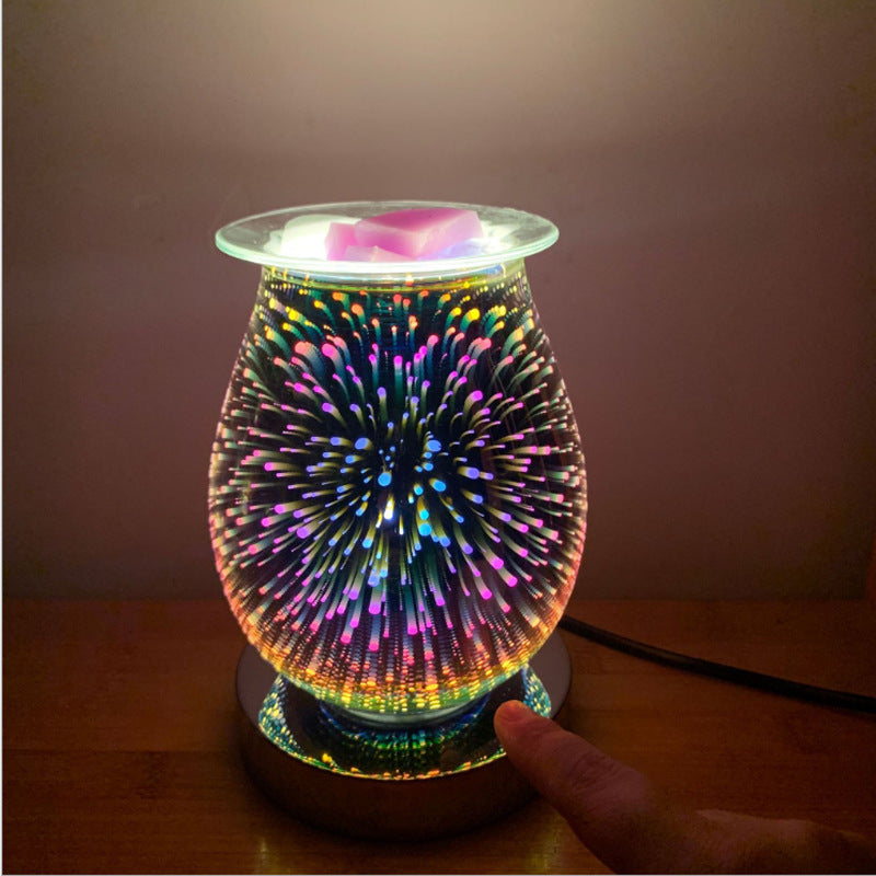 Hand touching the base of the lit glass firework aroma lamp
