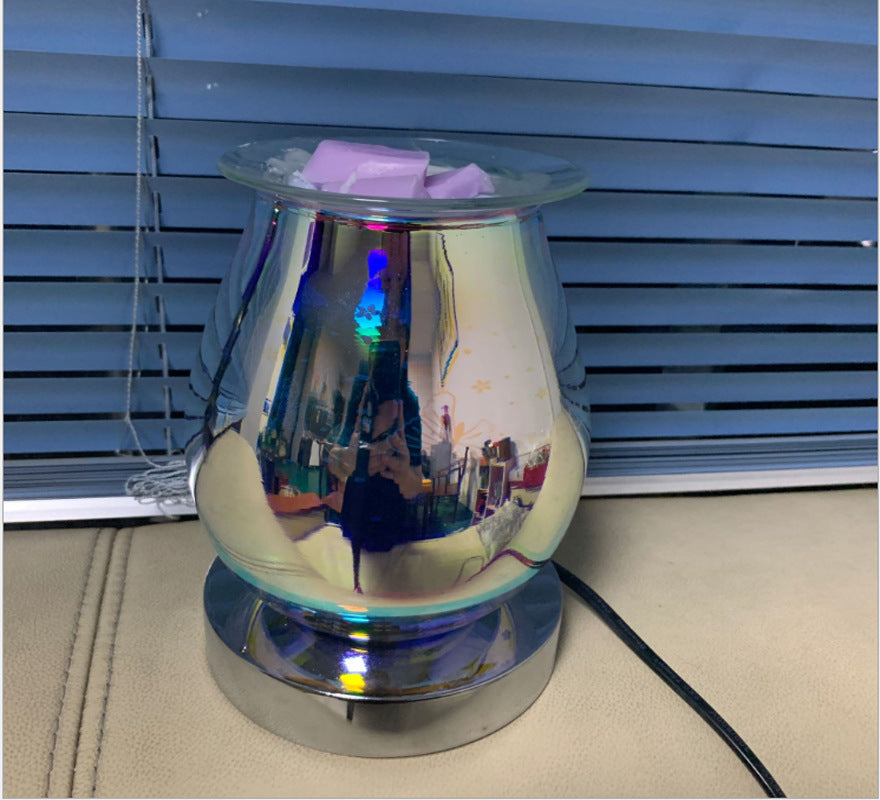 Chrome-finish firework aroma lamp, unlit, in front of a window blind