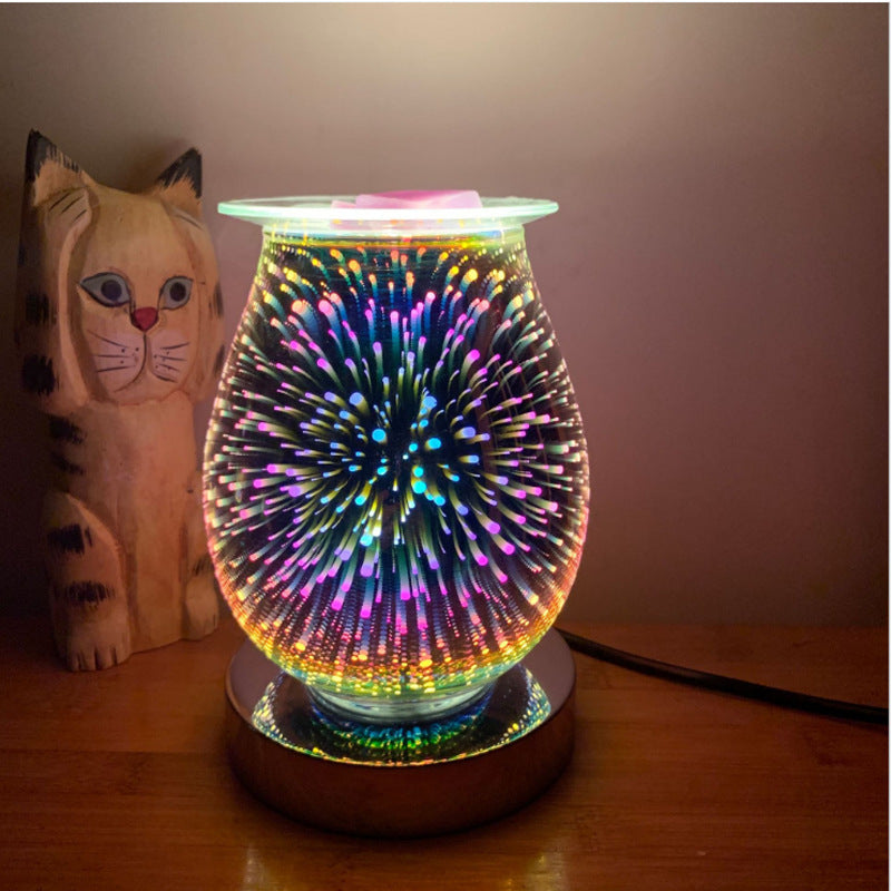 Glass firework aroma lamp lit in blue and purple on a wooden base