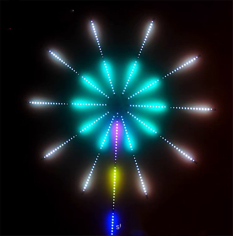 LED firework strip light lit in teal and white on a dark wall