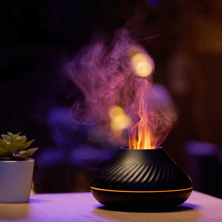 Black flame diffuser with a purple flame beside a small potted plant