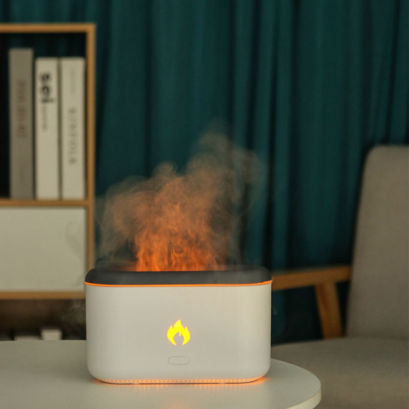 White 3D flame diffuser with the flame effect lit on a wooden table