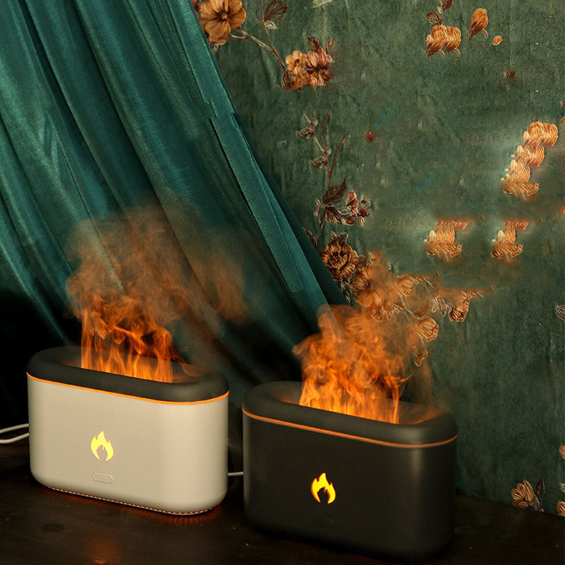 White and black 3D flame diffusers running side by side against a green curtain