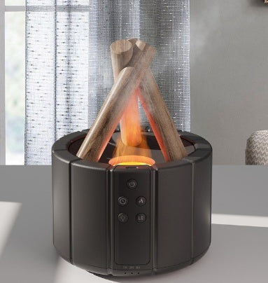 Black campfire-style diffuser with lit logs and mist, beside a window