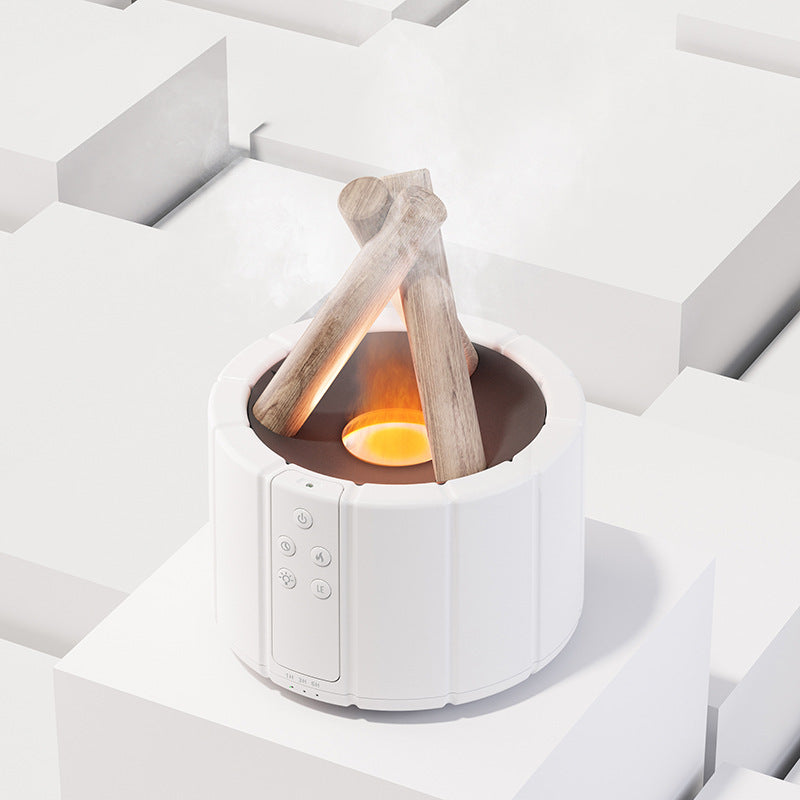 White campfire-style flame diffuser with the flame effect lit, plain background