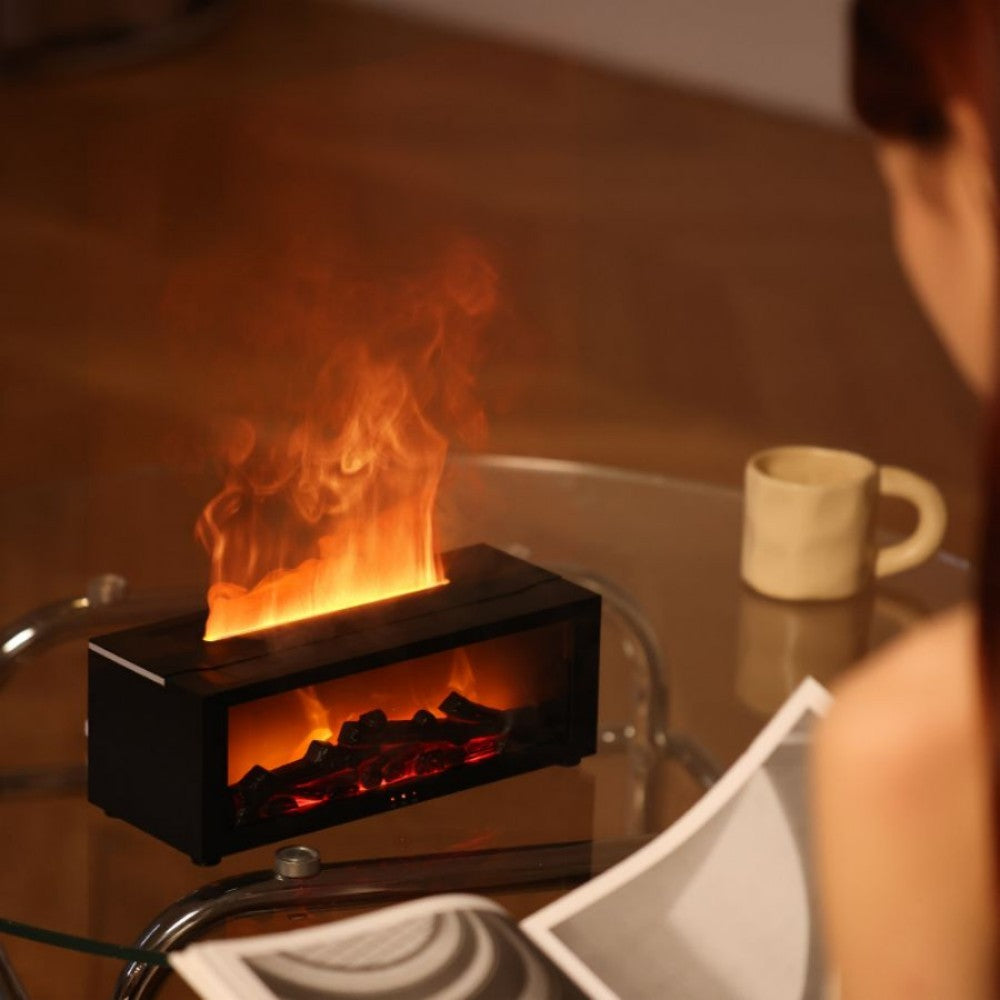 Fireplace aroma diffuser with the flame lit beside a ceramic mug